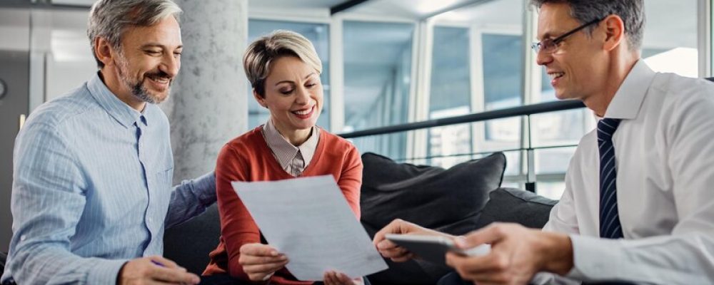 happy-couple-financial-advisor-going-through-plans-meeting_637285-11088